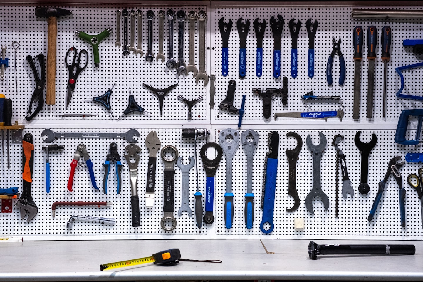 Bicycle maintenance tools arranged on a workshop wall